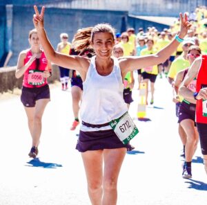 Woman in a running race giving victory sign